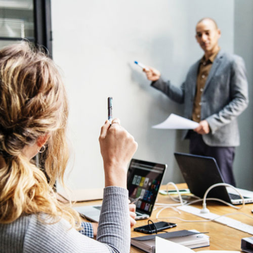 Person presenting by whiteboard