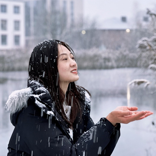 Image of He Wang in the snow outside WBS