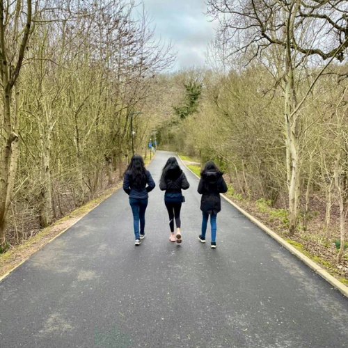 Three students walking on campus