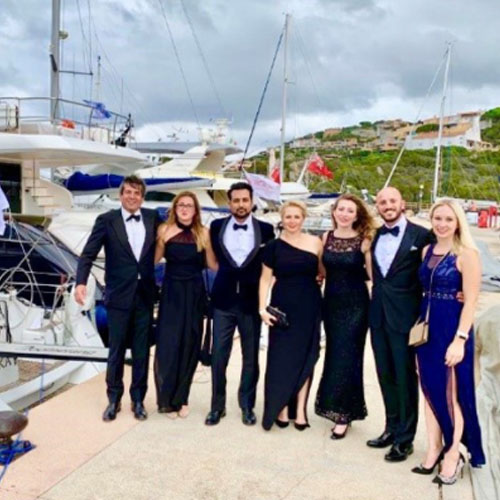 MBA students by boats in harbour 