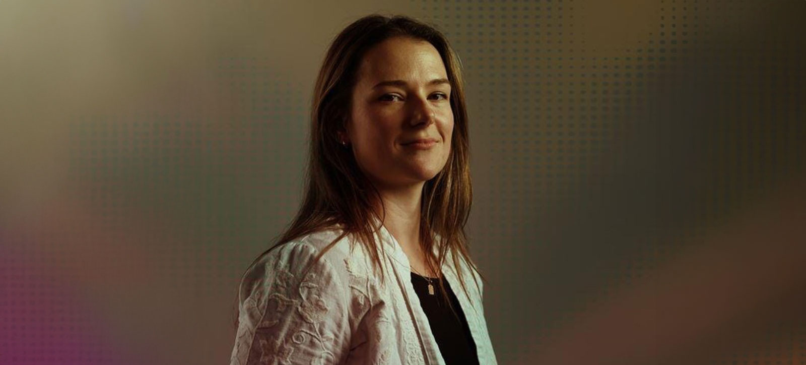 Jasmine Yeo, a WBS graduate, stood in front of a superimposed background smiling at the camera