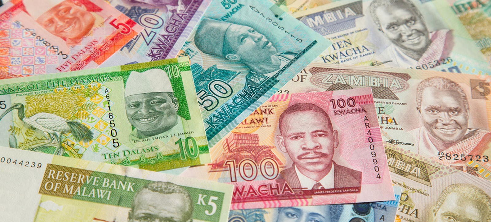 A collection of bank notes from different African countries - including Gambia, Zambia, and Malawi - spread out to fill the image.