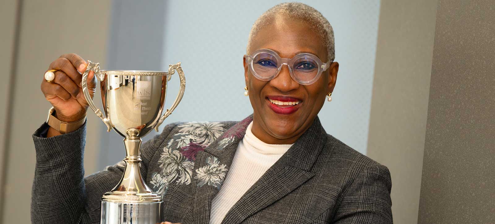 Dr Alero Onosode holding her DBA Thesis prize