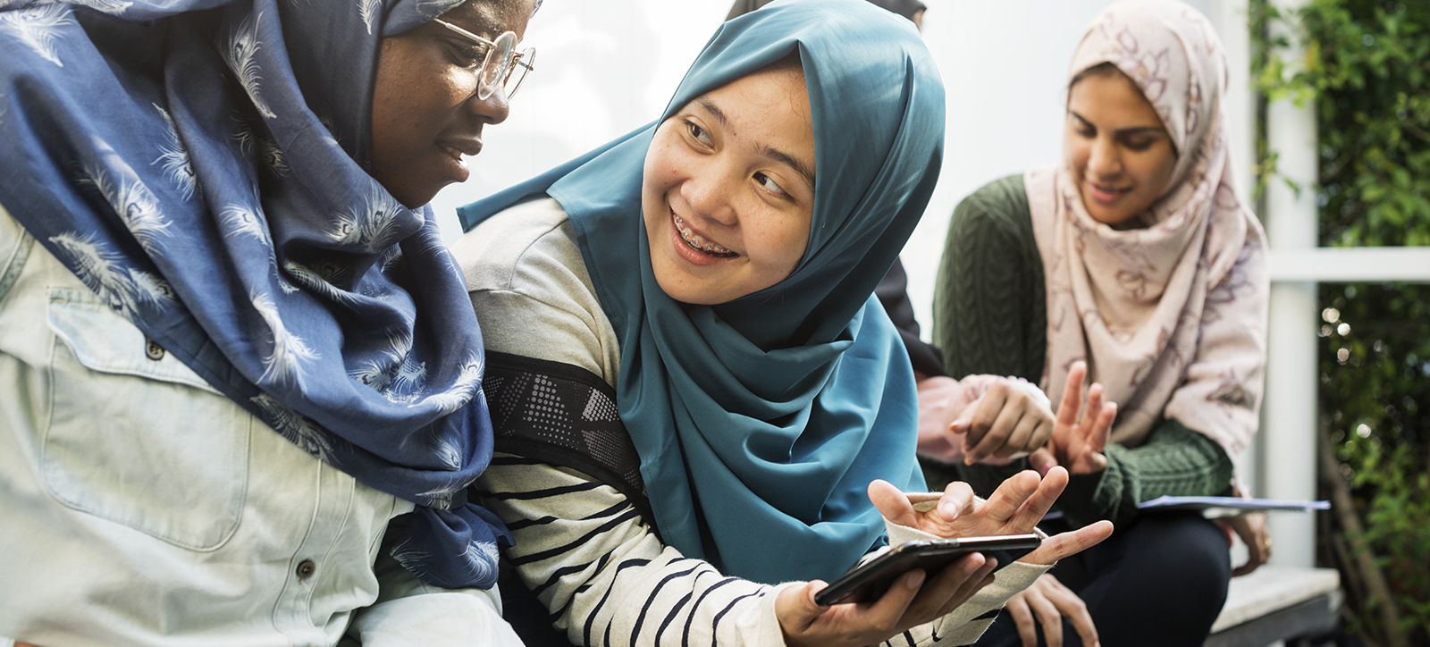 Young women in Pakistan using mobile phones.