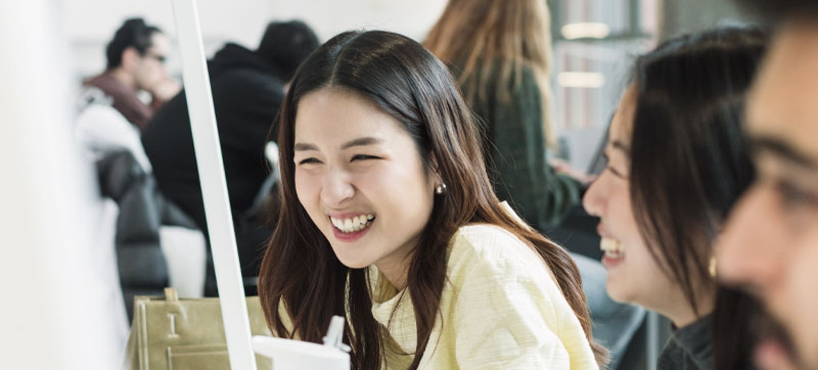 A Chinese girl laughing at Warwick Business School