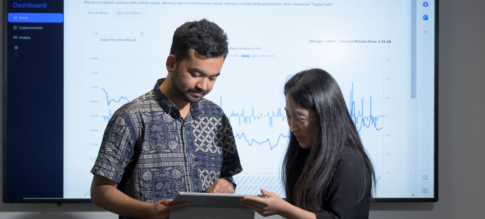 Two researchers explore the Crypto Dashboard at the Gillmore Centre for Financial Technology at Warwick Business School