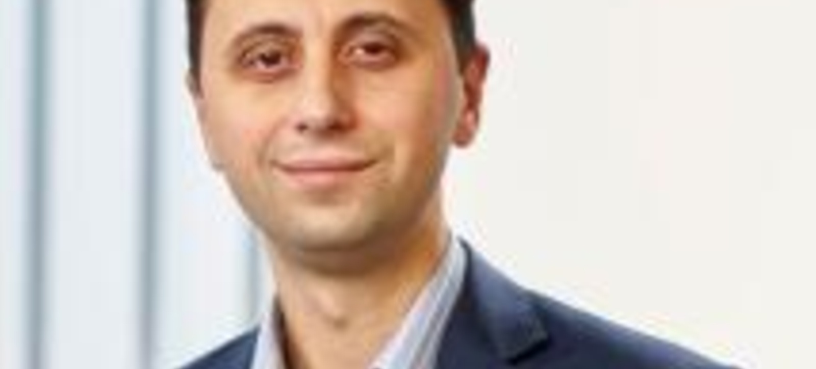 Professor Ivo Vlaev dressed in a suit smiling at the camera. Professor Ivo Vlaev dressed in a suit smiling at the camera.