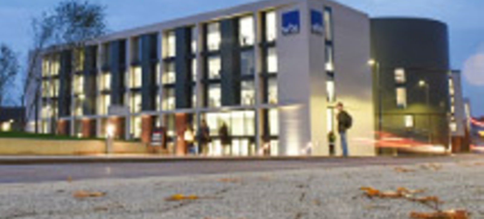 The main Warwick Business School building located in Coventry on the University of Warwick campus with students stood in front of it. The main Warwick Business School building located in Coventry on the University of Warwick campus with students stood in front of it.