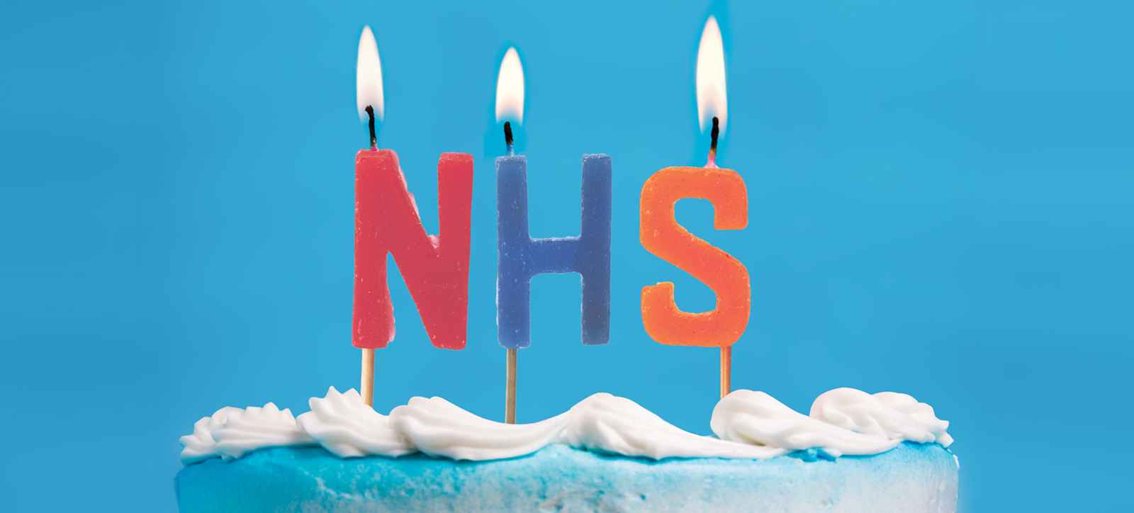A cake with N H S candles to mark the 75th anniversary of the NHS.