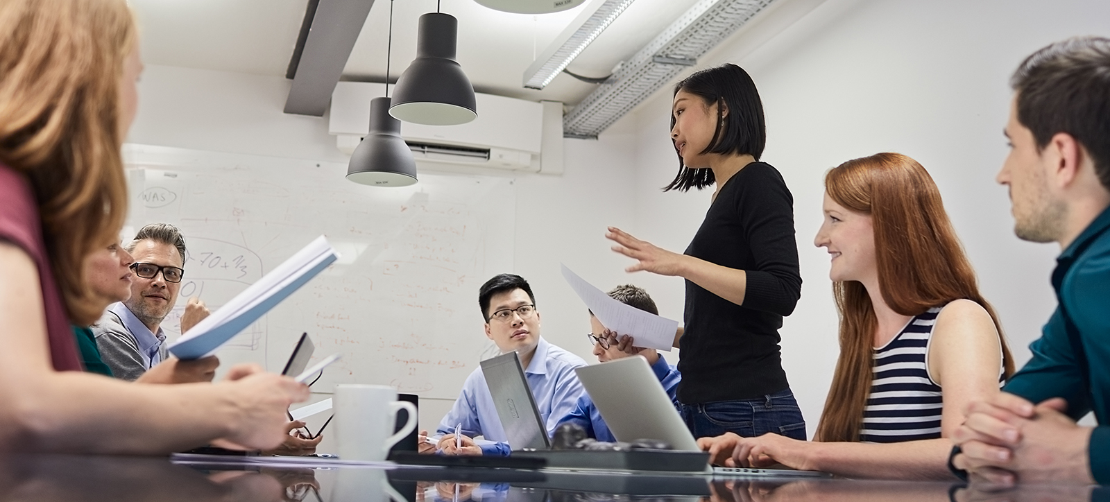 A team of employees discuss strategy during a business meeting