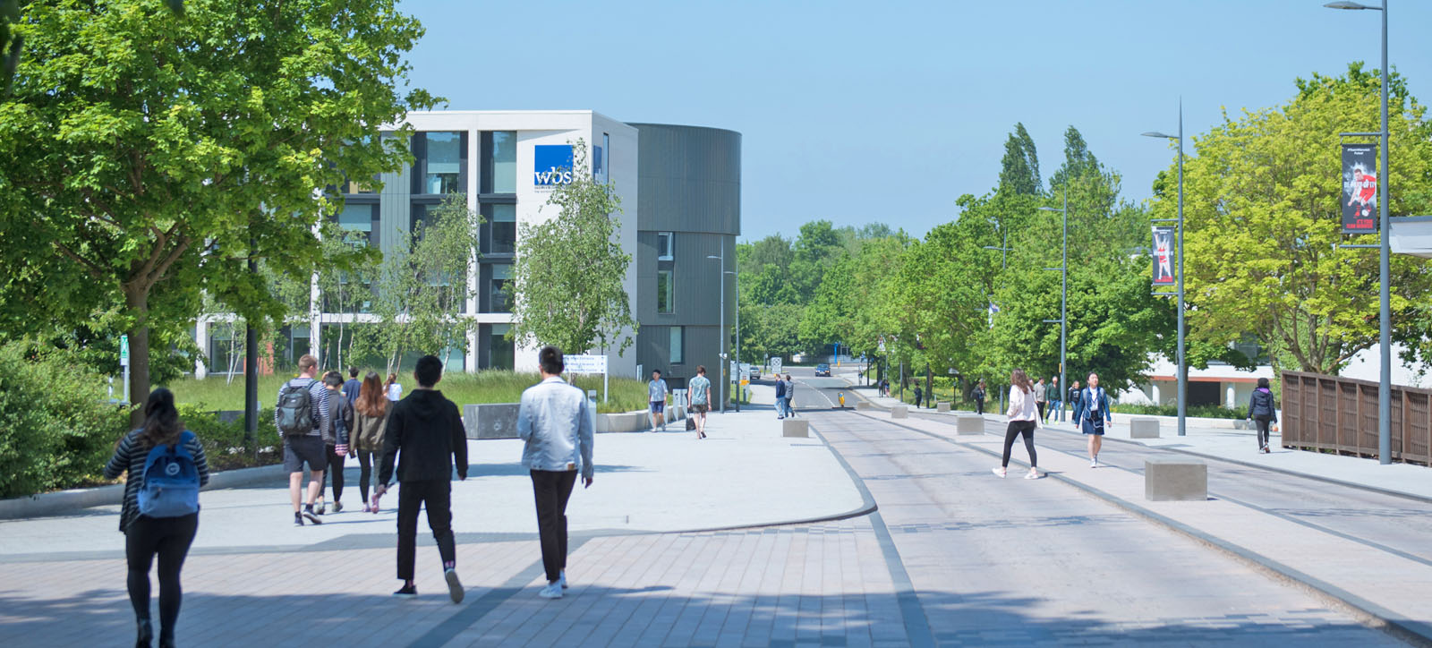 Groups of students walking around Warwick Campus with the Warwick Business School building in the background. Groups of students walking around Warwick Campus with the Warwick Business School building in the background.