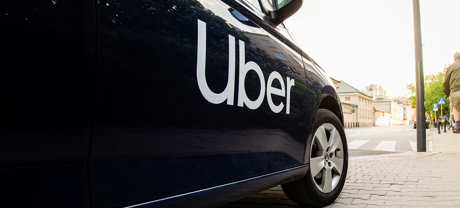 Black cab with Uber written on the side