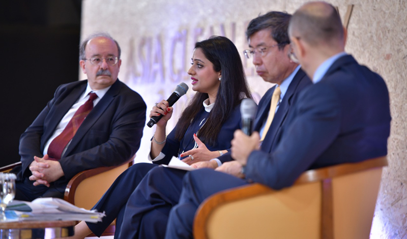 Fiza Farhan sat with a group of three others, delivering and talk holding a microphone. Fiza Farhan sat with a group of three others, delivering and talk holding a microphone.
