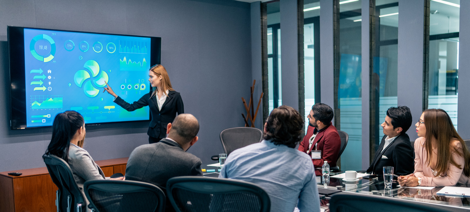 Office employee gives a Powerpoint presentation to colleagues