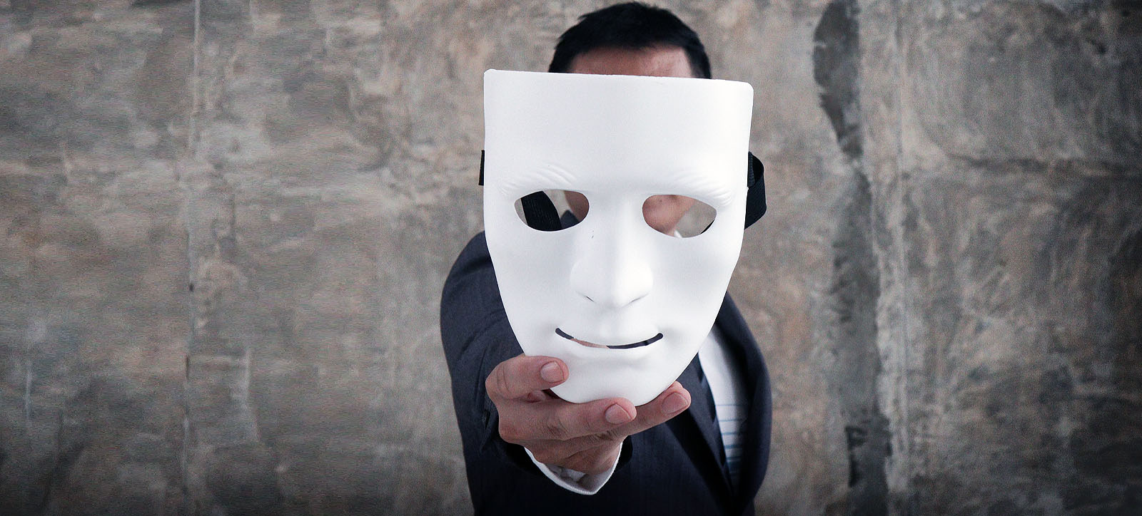 A man holding a mask