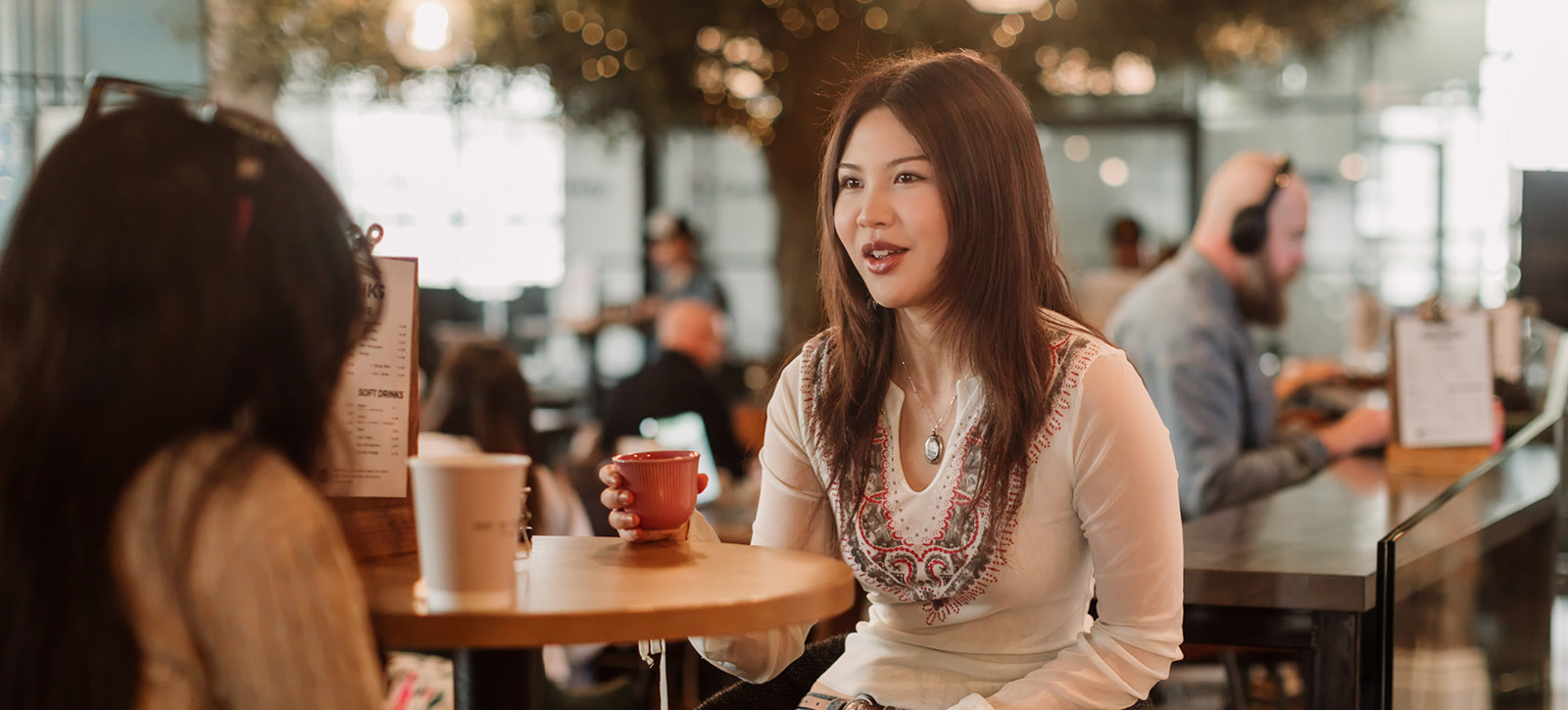 Two undergraduate students, girls, have a coffee at the WBS cafe