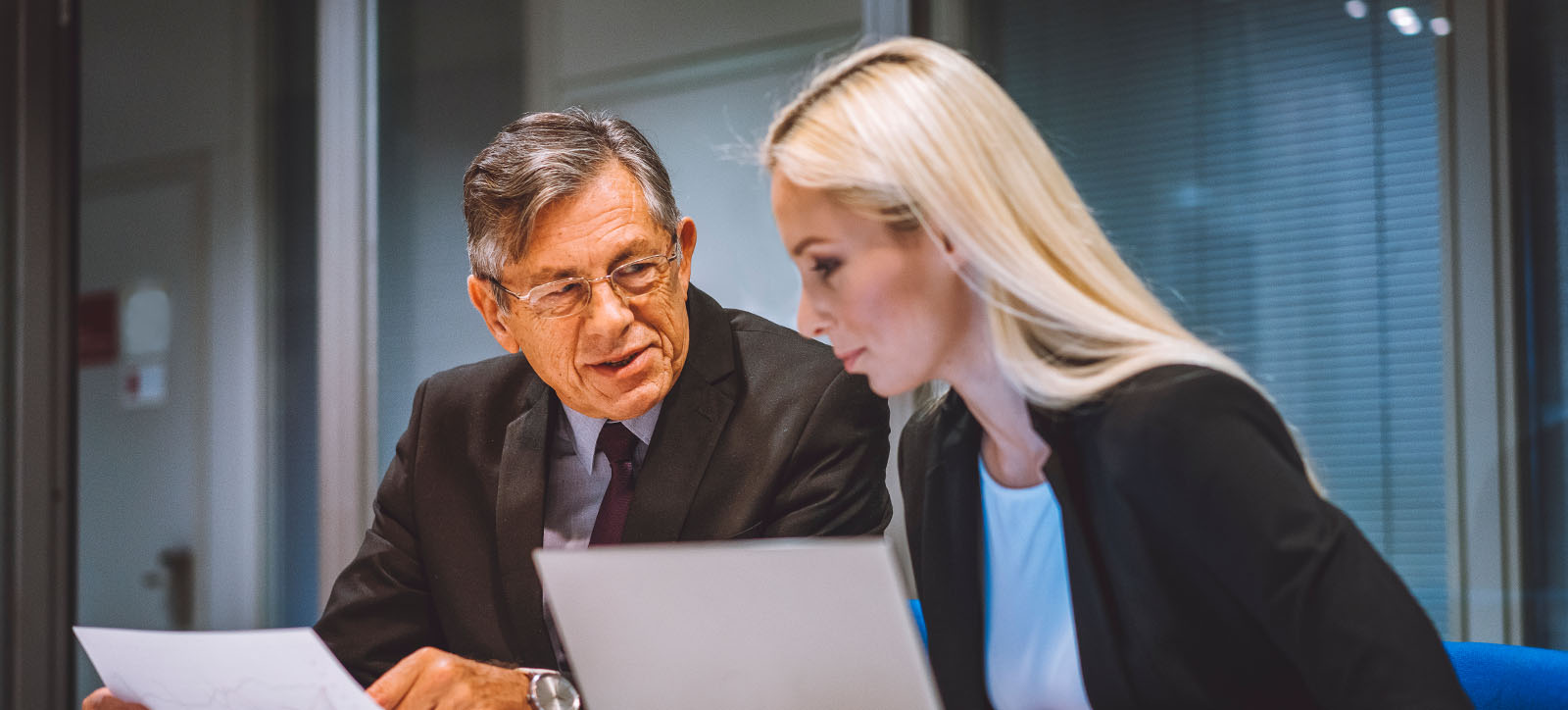 Old man and young woman talk business