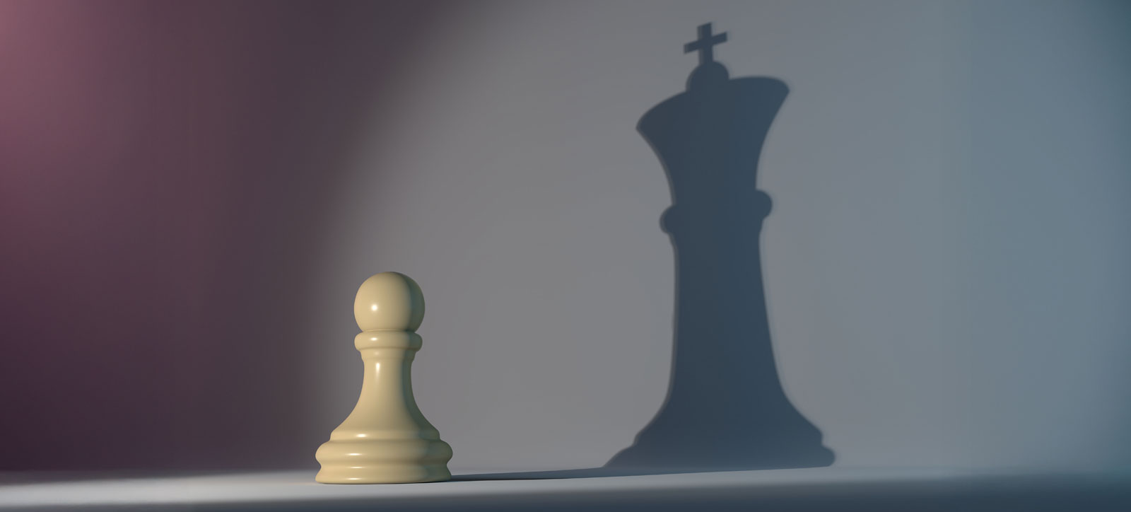 A light is shone on a pawn, casting the shadow of a larger king-shaped chess piece onto the wall behind. A light is shone on a pawn, casting the shadow of a larger king-shaped chess piece onto the wall behind.