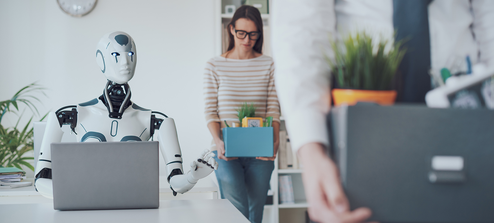 A robot manager sits behind a desk.