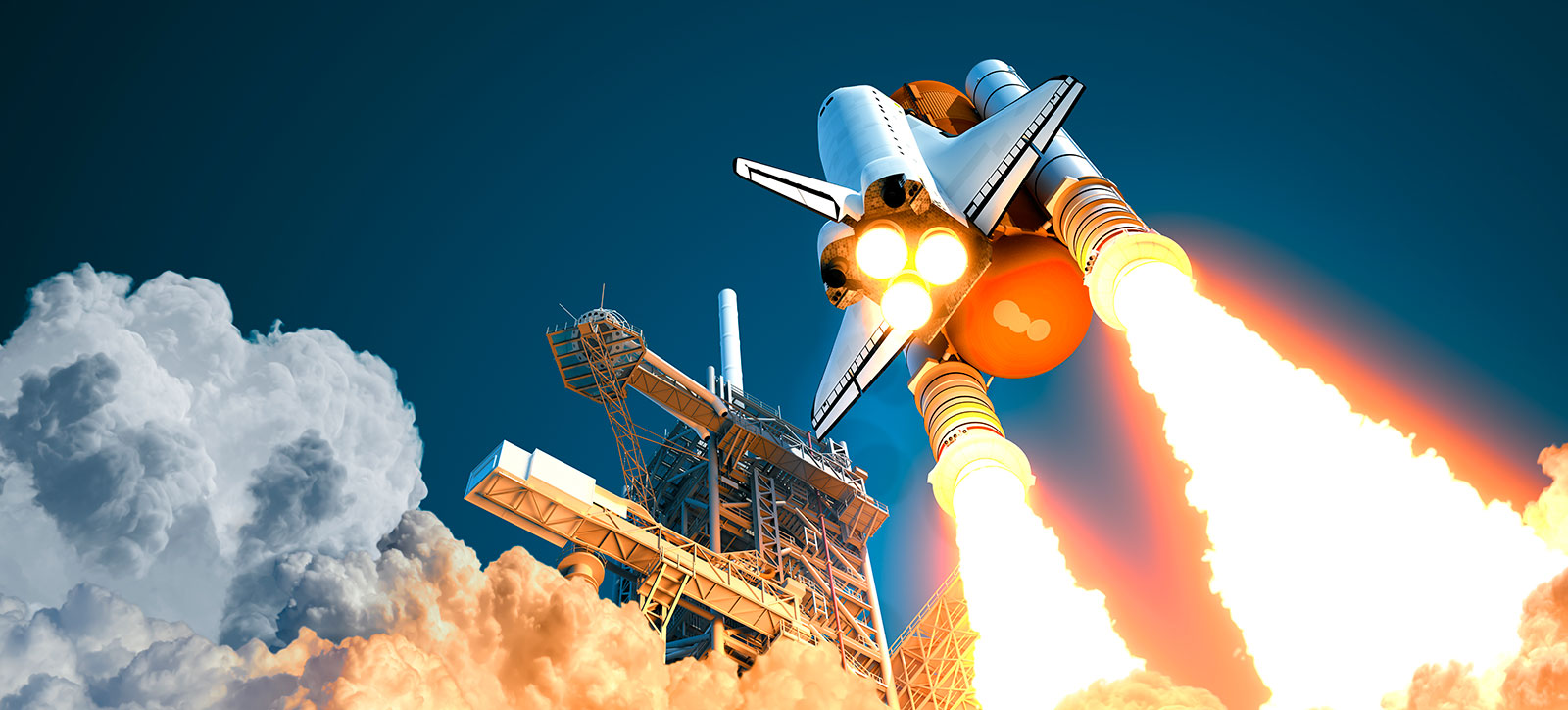 An image of a NS rocket carrying a space shuttle, viewed from below during lift off. Fire and smoke emerges from the thrusters as the rocket rises into the dark sky.