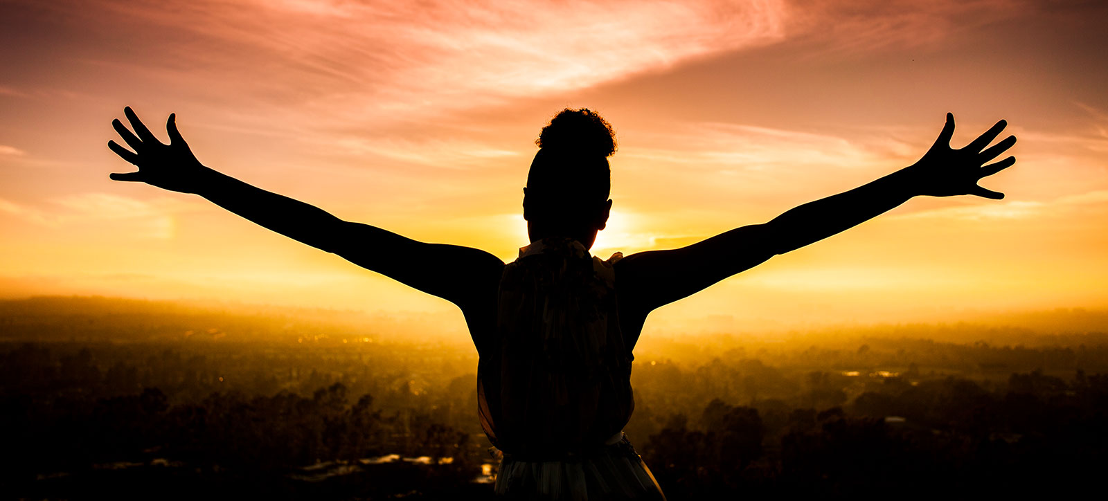 Woman Raising Arms at Sunset Woman Raising Arms at Sunset