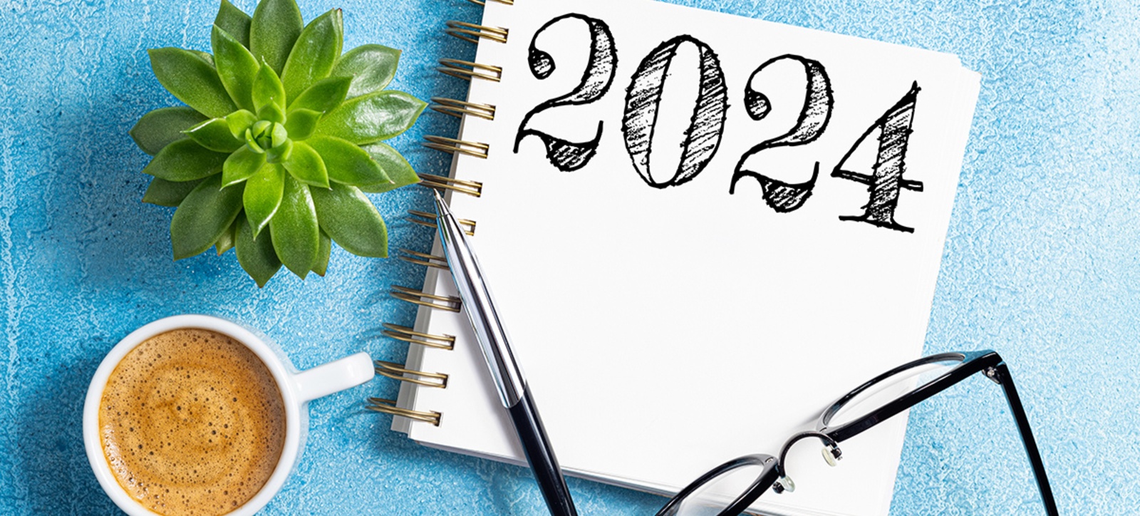 Notepad with the numbers 2024 written on it, alongside a cup of coffee, a pair of glasses, and a pen. Notepad with the numbers 2024 written on it, alongside a cup of coffee, a pair of glasses, and a pen.