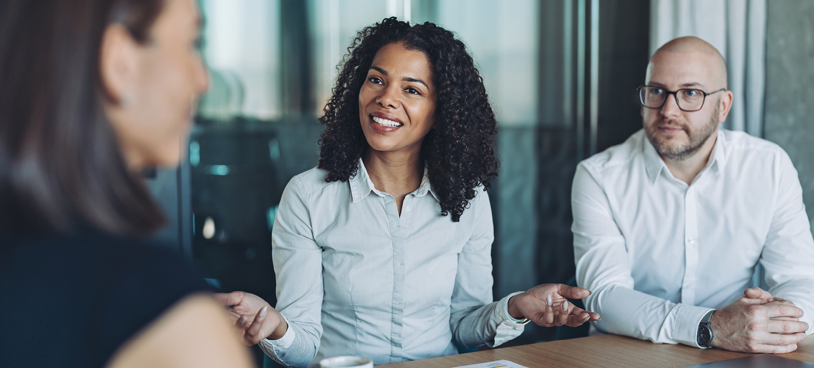 Smiling female entrepreneur working with colleagues in a meeting room