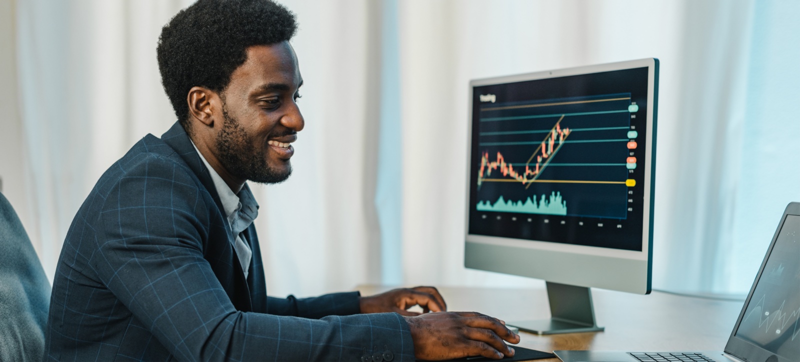 A salesman at his computer analysing data