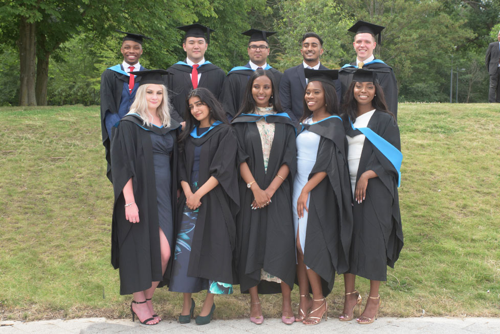 A group of students dressed in their graduation gowns and caps.
